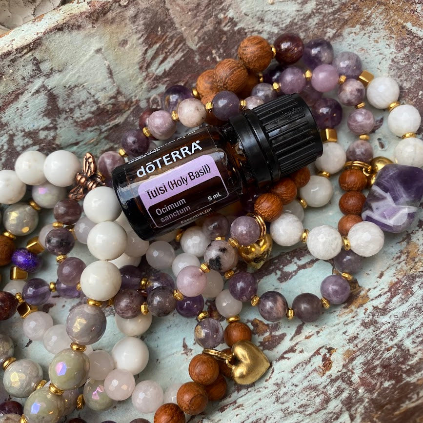 doTERRA essential oil bottle on a stack of multicolored beads